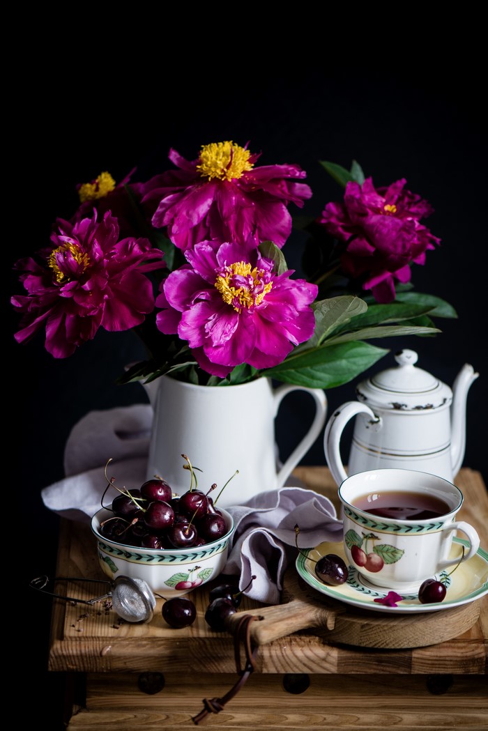 Still-life with peonies, cherries, tea, and kettle