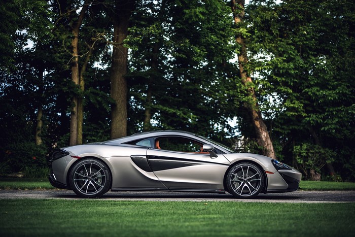 Silver McLaren 570S Coupe parked on grass