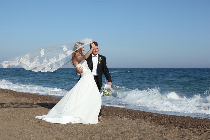 Bride and Groom on a Windy Beach