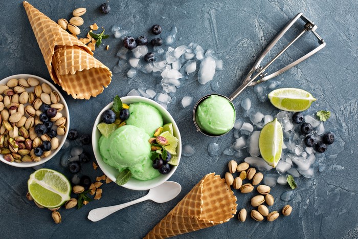 Green ice cream with blueberries, pistachios, and lime