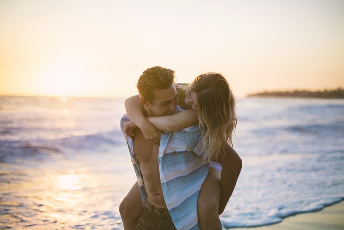 Couple in love on the beach at sunset
