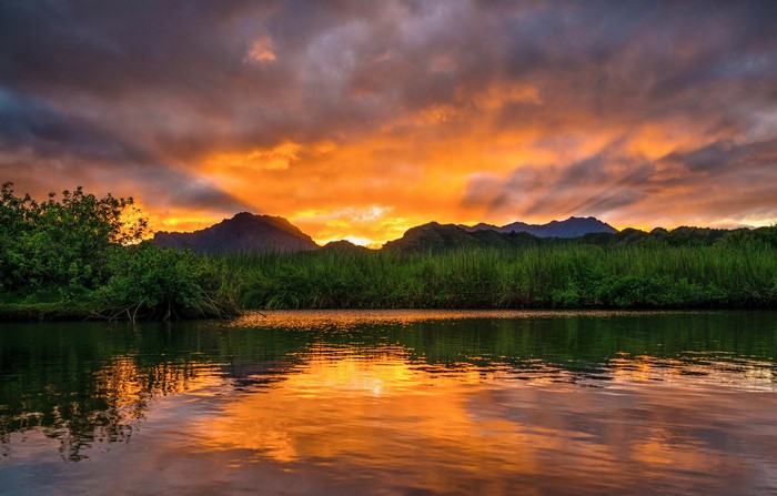 Sunset over mountains and river in Hawaii