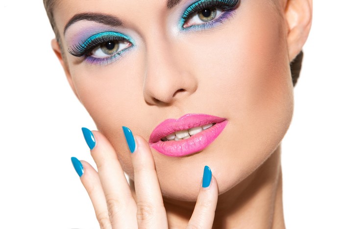 Woman with colorful makeup and blue nails