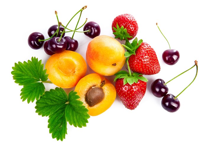 Strawberries, Cherries, and Apricots with Leaves on White Background