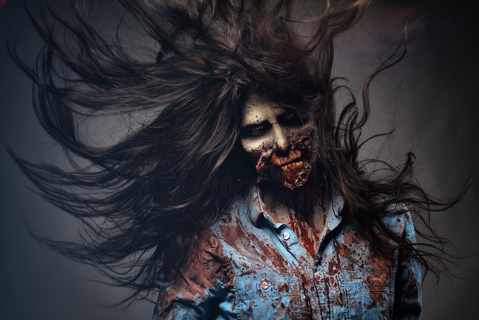 Zombie with flowing hair and bloody shirt