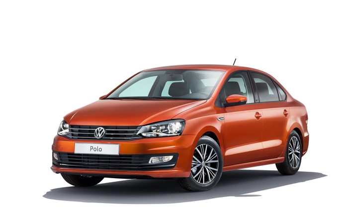 Orange Volkswagen Polo sedan on a white background
