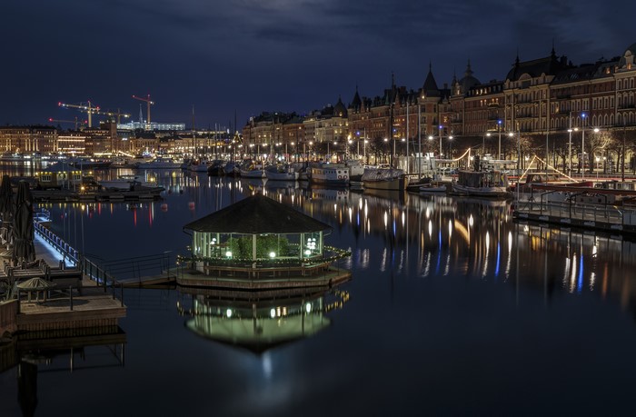 Stockholm at night with illuminated buildings and marina