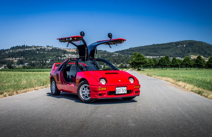 Red Autozam AZ-1 with Gullwing Doors on Road