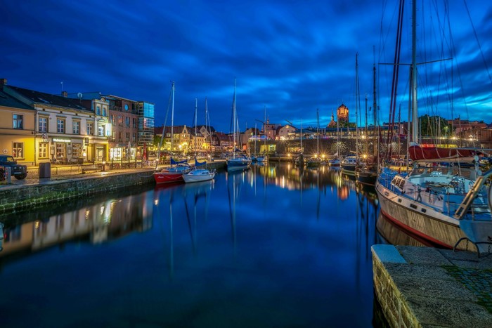 Boats docked in a harbor at night in Stralsund, Germany