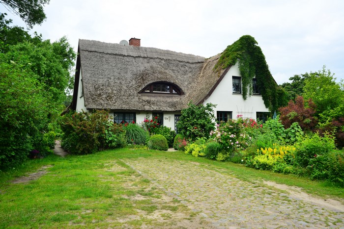 Thatched roof house in Gross Zicker, Germany with garden