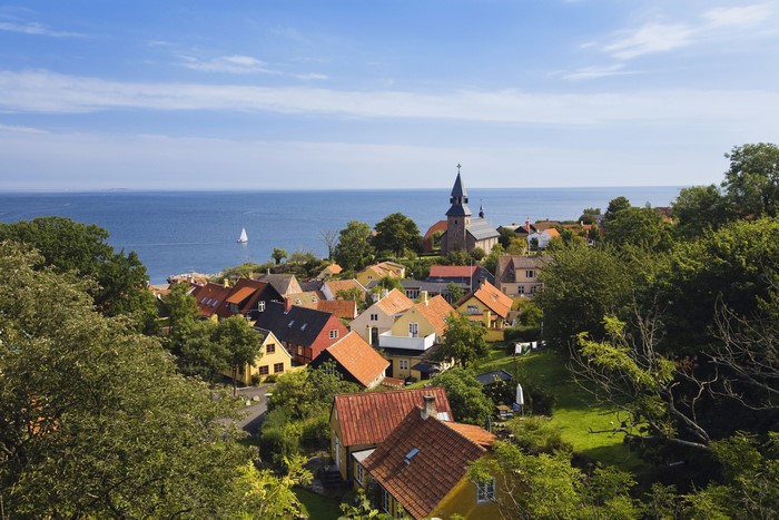 Coastal village with church and sailboat in Denmark