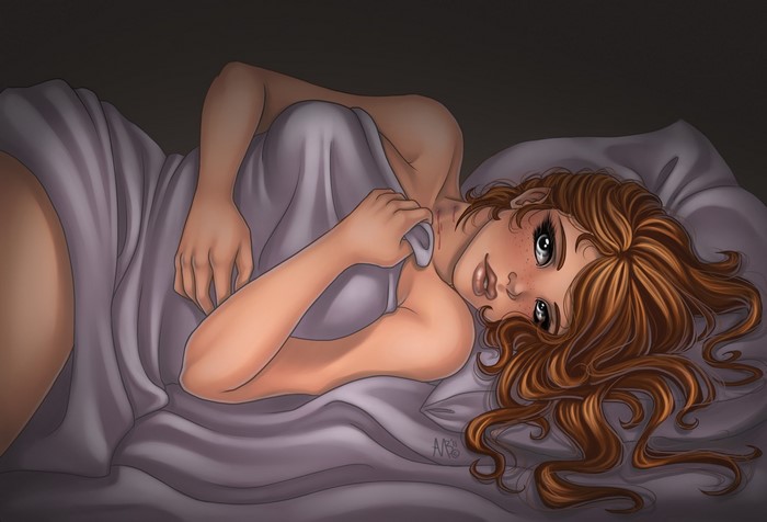 Brown-haired woman lying in bed