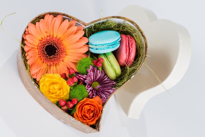 Heart-shaped box with gerberas and macarons