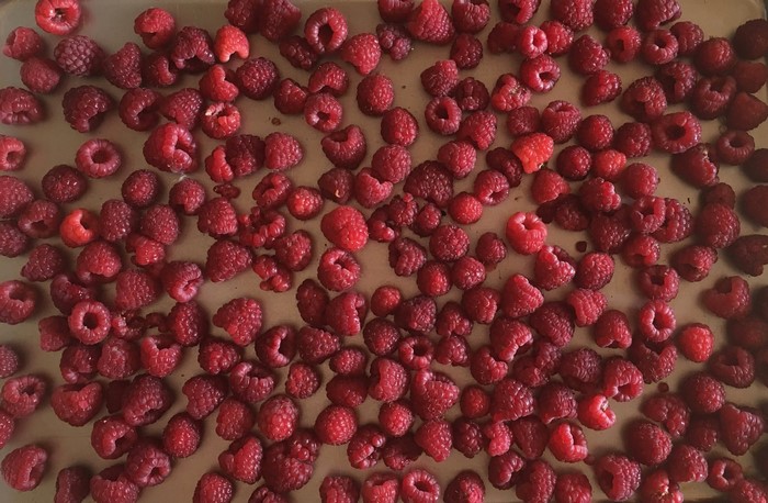 A large pile of fresh raspberries