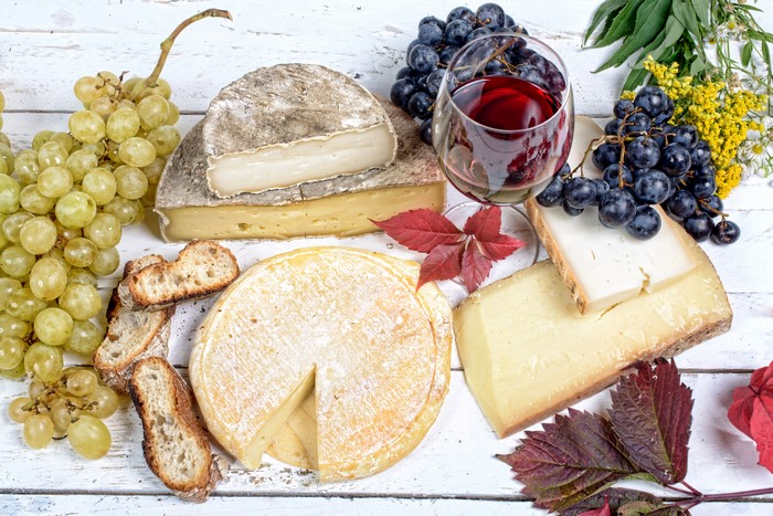 Cheese, Grapes, Wine, and Bread on a Table