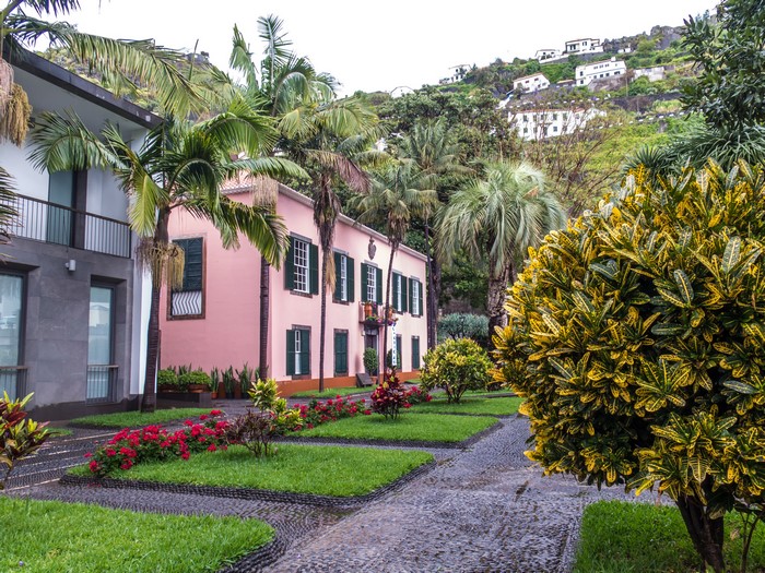 Pink house and modern building with garden in Madeira