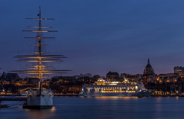 Tall ship and cruise liner in Stockholm at night