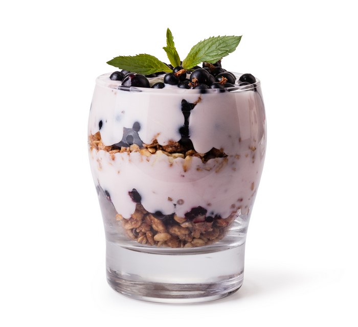 Yogurt parfait with muesli, currants, and mint in a glass