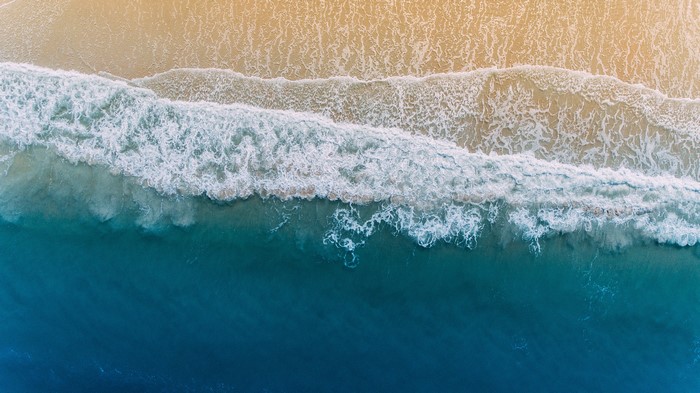 Aerial View of Waves Crashing on a Sandy Beach in Florida
