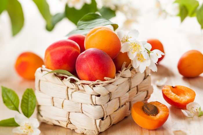 Apricots in a Wicker Basket with Jasmine Flowers