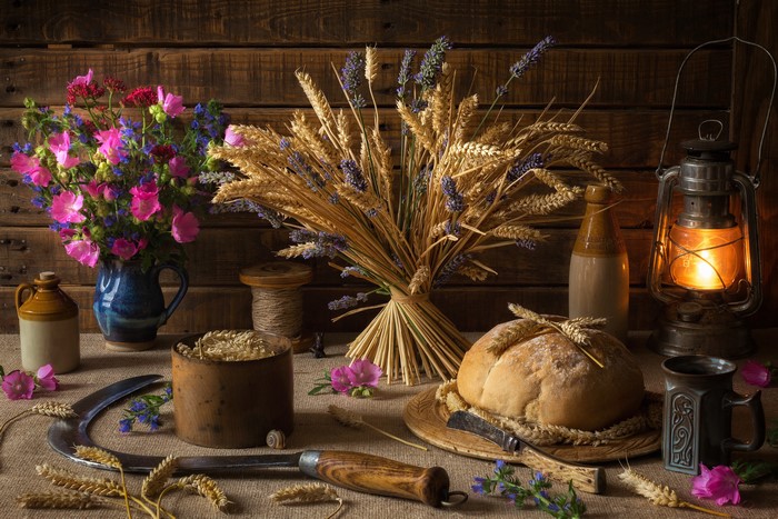 Still-life with bread, flowers, wheat, and kerosene lamp