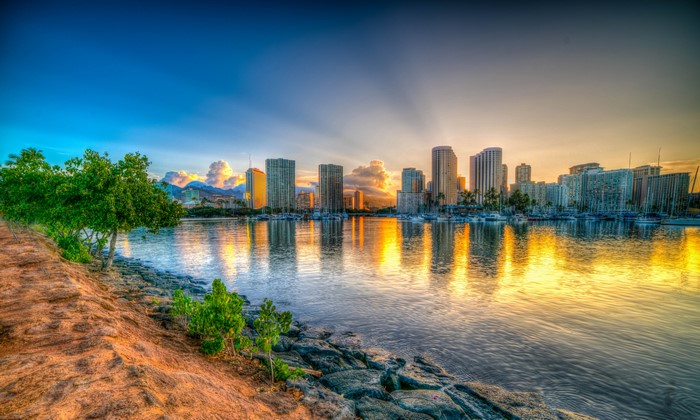Honolulu skyline at sunrise over bay with reflections