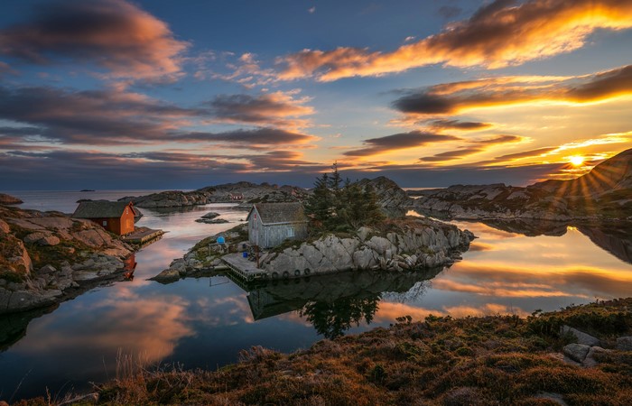 Sunset over islands with houses in Rogaland, Norway