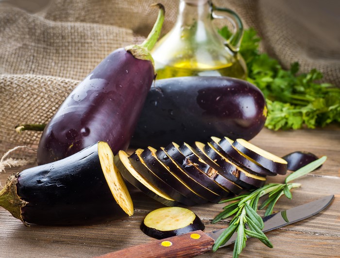 Eggplant on a wooden table with olive oil