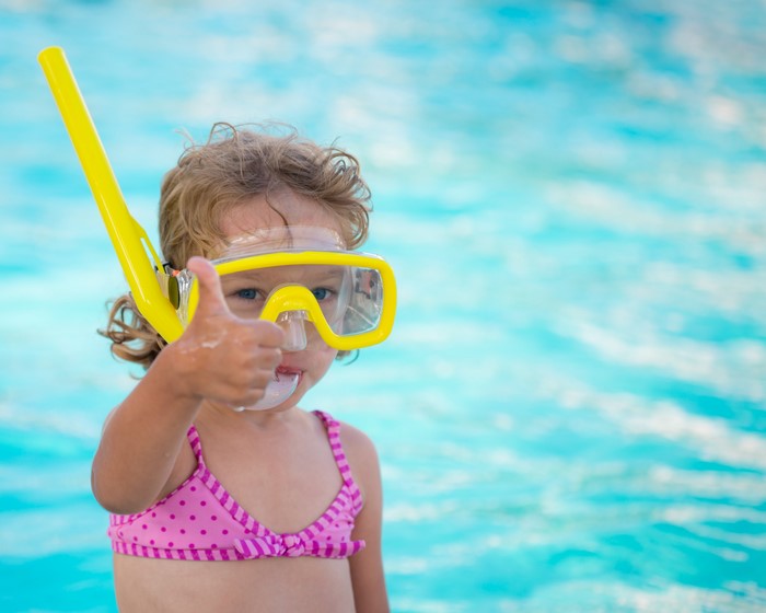 Girl in Goggles Gives Thumbs Up by Pool