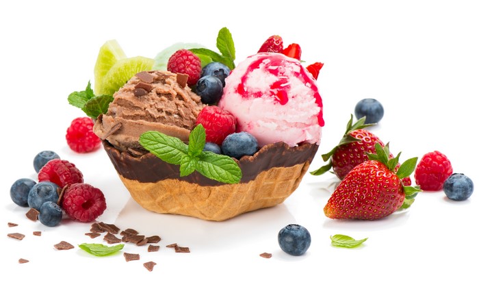 Ice cream with berries and chocolate in a waffle bowl