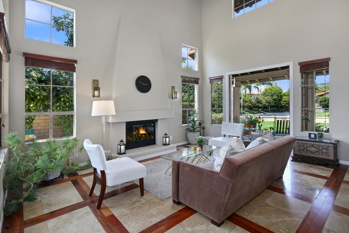 Living room with fireplace, sofa, and chairs