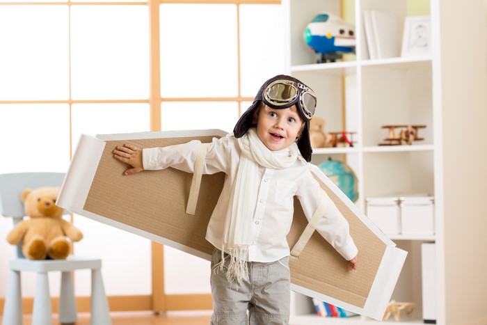 Boy with Cardboard Airplane Wings and Goggles