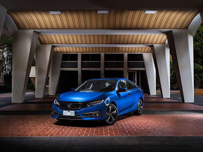 Blue Honda Civic Sedan RS parked under a modern building
