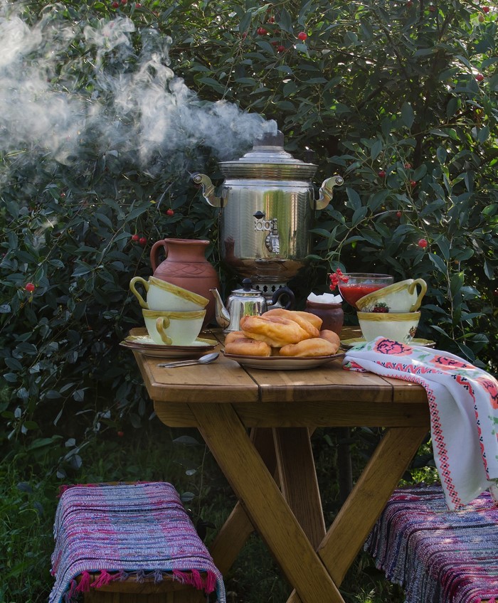 Outdoor tea setting with samovar and pastries