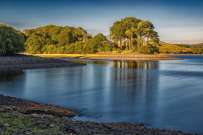 Killington Lake with trees and rocky shore
