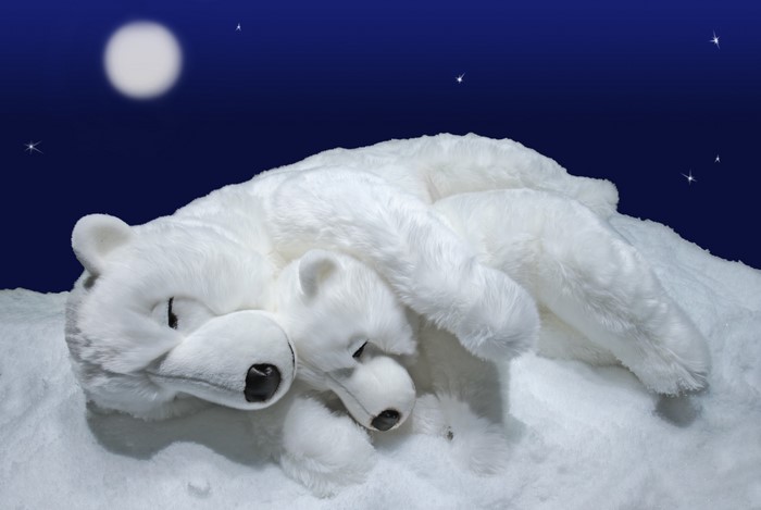Two polar bear toys sleeping on snow under the moon