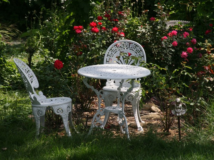 White cast iron table and chairs in a garden