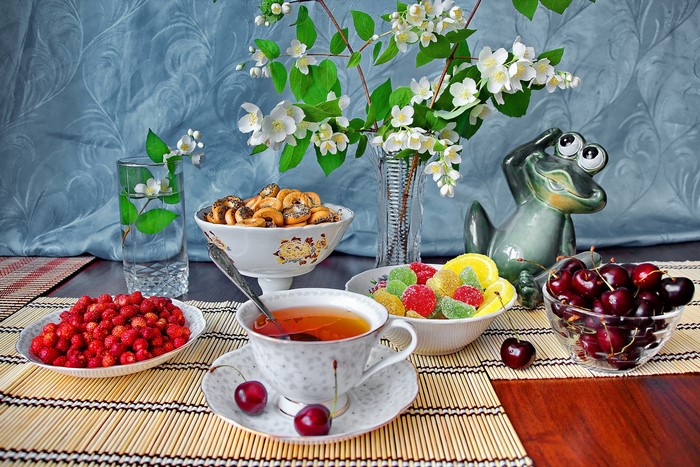 Still-life with tea, fruits, and flowers