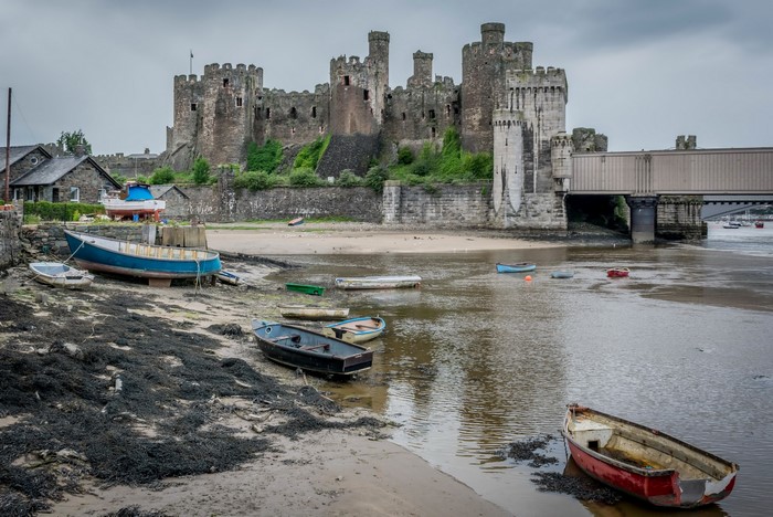 Conwy Castle and boats on the coast in Wales, United Kingdom
