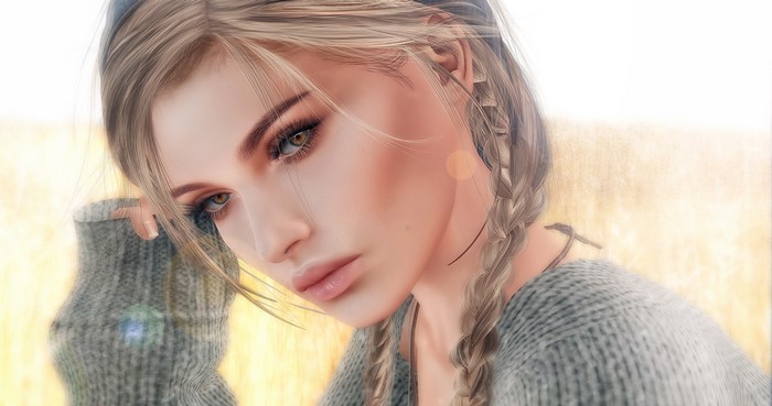 Close-up of a woman with dark blonde braided hair