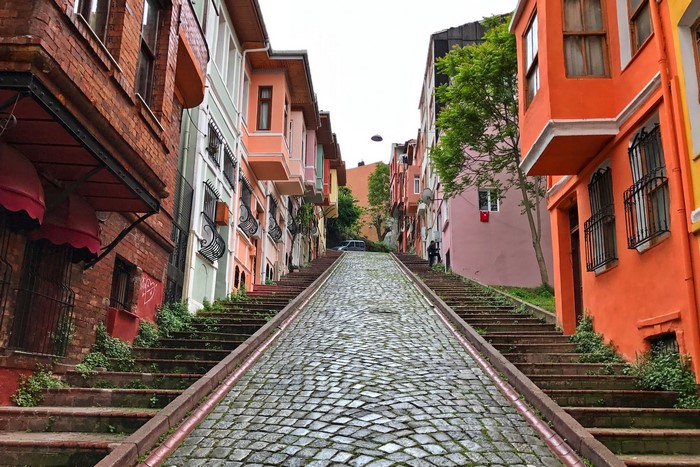 Colorful houses on a cobblestone street with stairs in Istanbul, Turkey