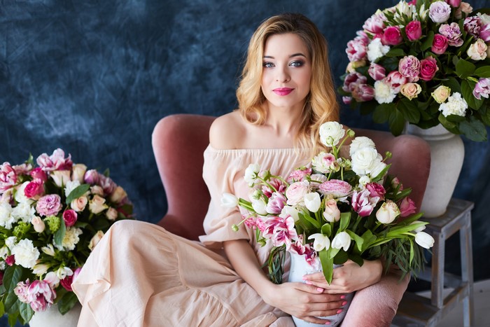 Blonde girl with bouquets of roses