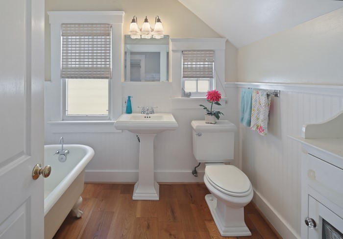 Bathroom with clawfoot tub, pedestal sink, and toilet