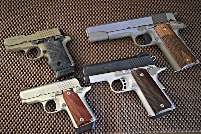 Four handguns: SIG P238, Kimber Ultra Carry II, Kimber Micro 380, Colt 9mm