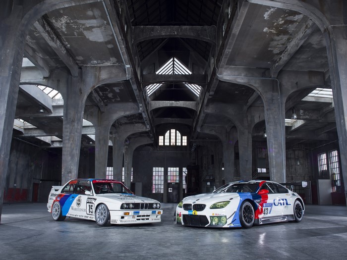 Two BMW M6 E30 cars in a warehouse