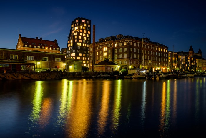 Copenhagen waterfront buildings at night with reflections