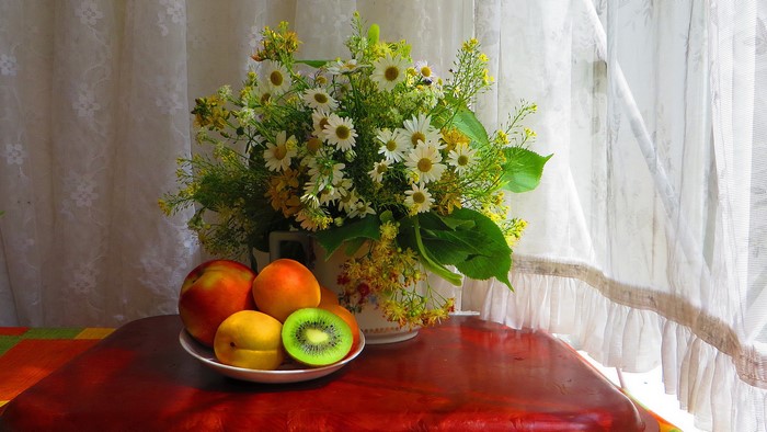 Still-life with bouquet of daisies and fruits