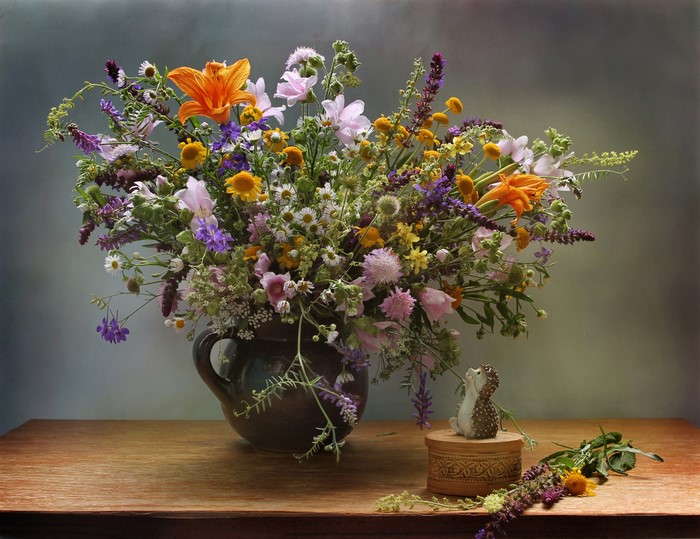 Bouquet of wildflowers in a vase with a hedgehog figurine