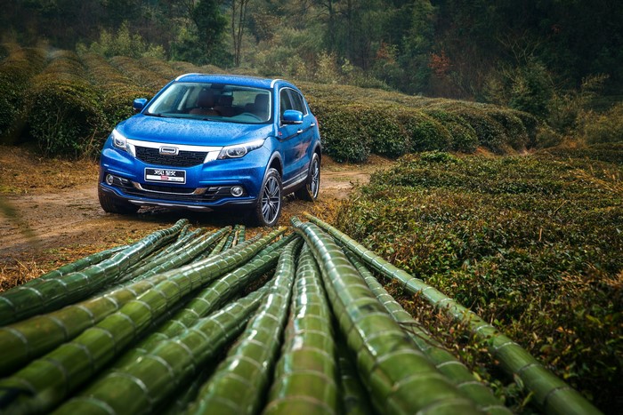 2016 Qoros 5 SUV in a rainy tea plantation