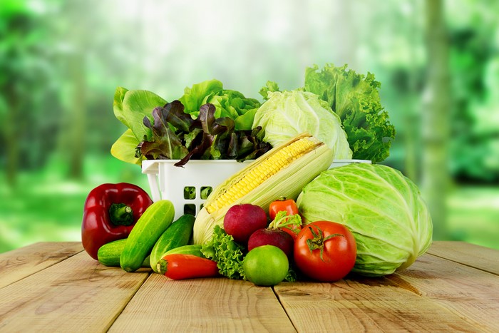 Assortment of fresh vegetables on wooden planks